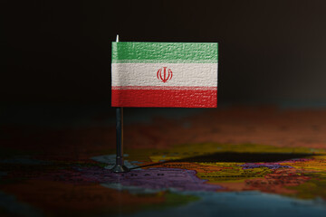Iran flag pin placed on a map, symbolizing location, politics, or national identity.