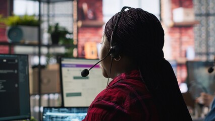 Call center worker in office using AI chatbot to provide quick replies to common customer queries....