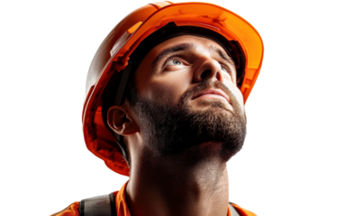 Focused construction worker in safety gear looking upwards with determination, showcasing commitment to safety and hard work in industrial environment