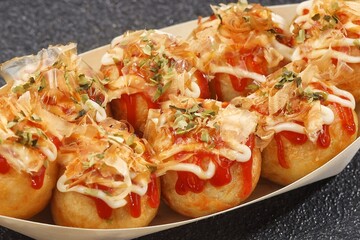 Takoyaki is a typical Japanese snack in the form of small balls made from wheat flour dough and filled with pieces of octopus.
