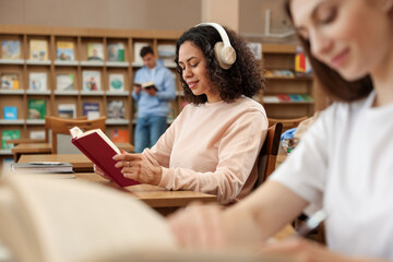 People studying in public library, selective focus