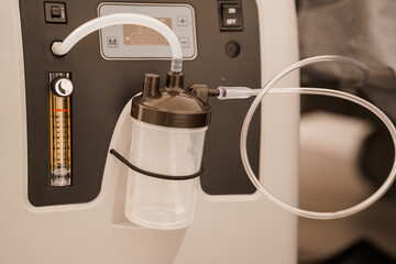 Medical Oxygen Concentrator with Humidifier Bottle, White Cabinet, Digital Display, and Tubing. Healthcare Equipment, Hospital Setting, Light Tone.