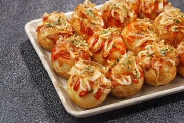 Takoyaki is a food from the Kansai region in Japan. in the form of small balls with a diameter of 3-5 cm made from wheat flour dough filled with pieces of octopus inside