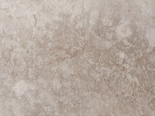Rough textured light beige surface resembling natural stone or concrete, ideal for backgrounds,...
