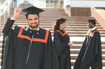 education, graduation and people concept - happy Indian Male graduate student