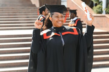 pretty african university graduate at graduation ceremony