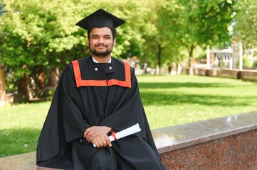 education, graduation and people concept - happy Indian Male graduate student