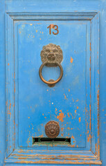 Vintage blue door with lion head knocker and number 13 in Le Panier, Marseille, Marseilles, France.. Mediterranean texture, Provence charm, old town detail