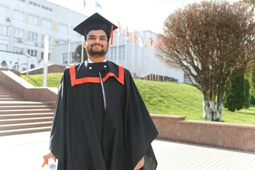 Portrait of happy man, graduation or student in university campus