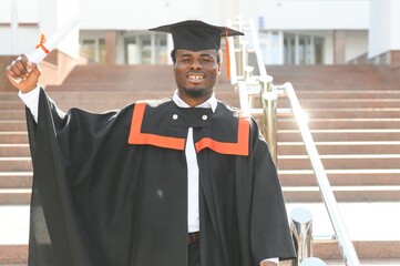 Happy graduate. Happy African man in graduation gowns