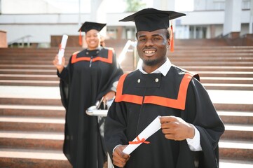 Happy graduate. Happy African man in graduation gowns