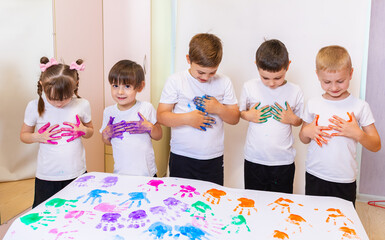 Creative Kids Expressing Themselves Through Colorful Handprints During an Art Activity in a Bright...