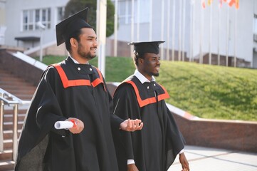Happy boys students university graduates. Multiracial students