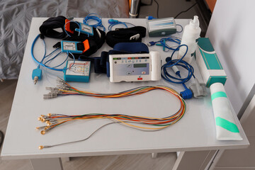 Stationary Polysomnography System Setup on Bedside Table with Cables and Monitoring Equipment,...