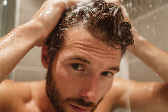 a man is washing his hair in the shower