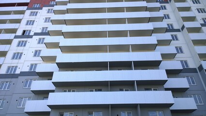 Facade of new multi-story residential building. Sale and rental apartments. Housing development....