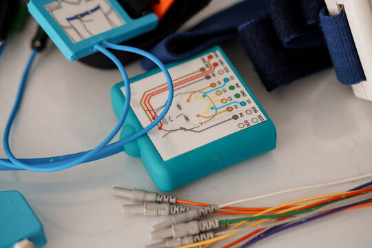 Polysomnography System Setup: Medical Sleep Study Device with Cables, Electrodes, and Blue Color Scheme, Clinical Healthcare Technology.