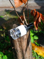 plain perfume bottle on the natural woods background