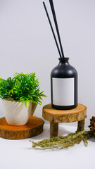 reed diffuser bottle with plain white label on the wooden podium minimalist studio scene