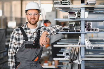 Factory worker. Man with helmet working with pvc
