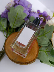 Perfume bottle mockup on wooden coaster with plain white label, flowers background decoration,...