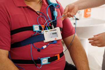 Patient Monitoring with Wearable EKG Device During Sleep Study, Red Shirt, Hospital Setting,...