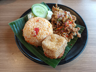 Nasi Goreng with Crispy Chicken, Fried Tofu, and Sambal Matah
