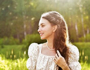 Beautiful Young Woman Outdoors. Beautiful young woman walking in the park, enjoying nature on a...
