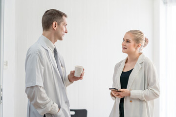 Senior male doctor and female patient discussing in detailed about health concerns and possible treatment plans at hospital. Medicine and health care concept