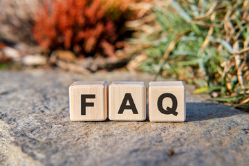 Fag text on cubes standing on a stone on a natural background