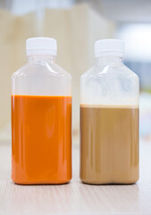 Thai milk tea and coffee in plastic bottles with white lid on table at office