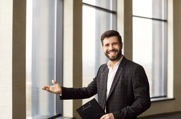 Sure confident smiling male realtor showing, real estate agent presenting apartment window,...