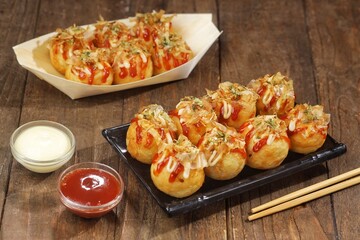 Takoyaki is a typical Japanese snack in the form of small balls made from wheat flour dough and filled with pieces of octopus.