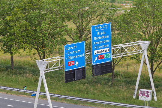 Dutch highway signs near Utrecht direct traffic to major cities like Amsterdam, Rotterdam, and Breda, with the Jaarbeurs and A27/A28 indicated. Utrecht, Netherlands, 12 June 2025.