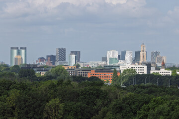 A wide view of the Utrecht skyline, showing a blend of contemporary high-rises and the historic Dom...
