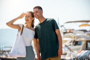 Couple Holding Hands Walking Around Yacht Deck, Amazed by Luxury Boats