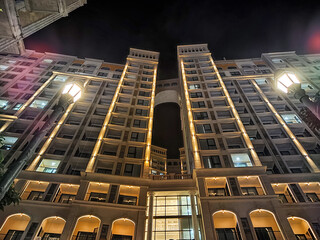 Contemporary architecture comes alive at night, bathed in the soft glow of warm lights that...