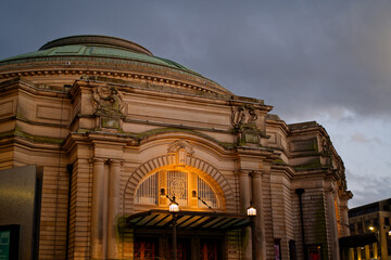 Illuminated Usher Hall in Edinburgh at dusk with clouds. Facade of historic building in the city...