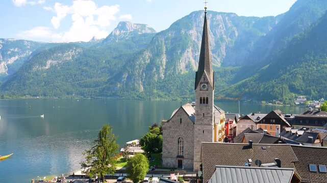 Idyllic Hallstatt with reflection in the lake water - old town, Austria. Big Panorama - 4K Video.