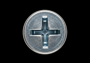 Metallic Fastener Phillips Head Close Up. Intricate view of a silver bolt top with cross recess on black. Signifies engineering, precision, and robust connections.
