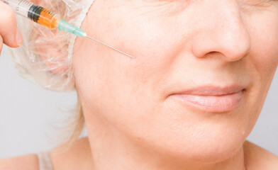 Contour plastic surgery with hyaluronic acid injections in a cosmetology clinic for facial skin.
