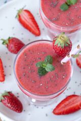 Strawberry smoothie with chia seeds for healthy summer breakfast. Top view.