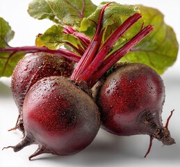 Freshly picked beetroots with vibrant leaves, glistening with water droplets, showcasing rich color and organic farm produce aesthetic for culinary use