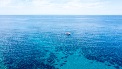 Boat in Clear Blue Coastal Waters