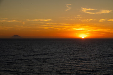 Sunset Over Sea with Stromboli in Distance