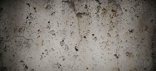 Grunge-style old concrete wall texture featuring dirt, cracks, and natural wear, perfect for backgrounds and design overlays. 