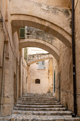 Stone stairway alley with arches in Matera