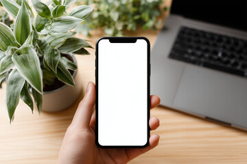Hands holding smartphone with white screen at clean modern desk
