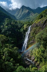 Obraz premium Waterfall cascading down lush green mountainside with rainbow in reunion island