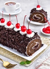 Soft and fluffy black forest roll cake with strong delicious chocolate flavour, rolled with...